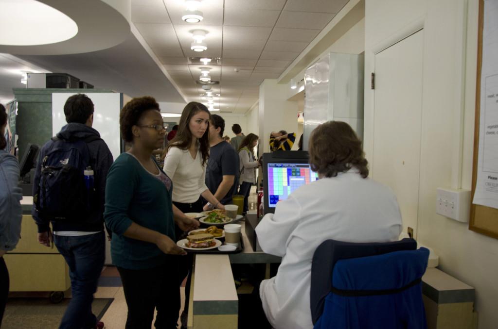 Students dining in Dascomb Hall wait in line behind the cash register. Dascomb has recently attained a reputation of being stricter with food portions — a status 
that has proved disagreeable among a number of students.