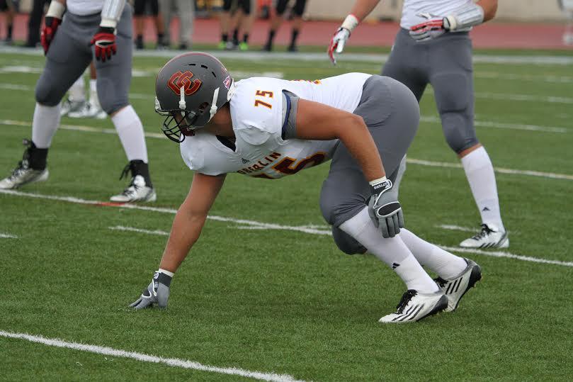 Senior defensive lineman Kirby Livingston assumes a three point stance. Despite lackluster results this season, the football team remained positive. 