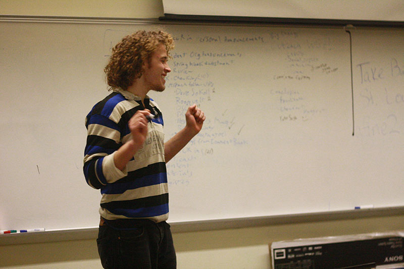 College junior Andrew Follman leads students at a RIO meeting on Thursday night. The organization will host a responsible investing symposium on March 8 and 9.