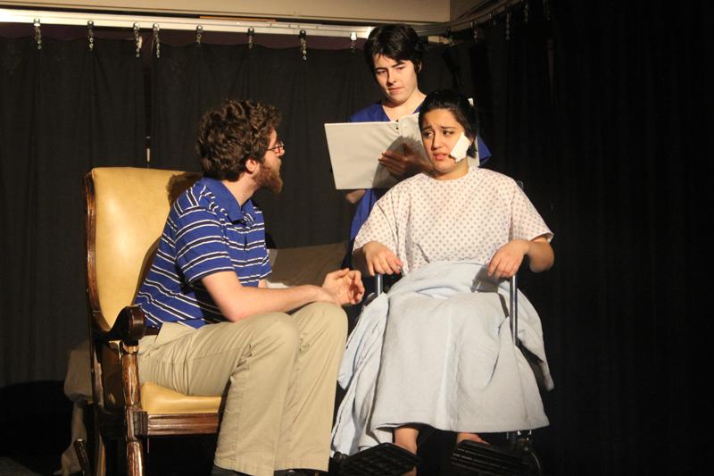 (From left) Peter, played by College sophomore Andrew Hartley and Callie, played by College sophomore Amelia Durham comfort Sara, played by College first-year Roux Namaei, after she is the victim of a brutal hate crime. Stop Kiss bravely takes an inside perspective on same-sex relationships, which are rarely shown on stage. 