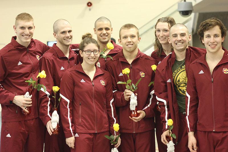 Seniors Jordan Attwood (left), Luke Harrison, Kelin Michael, Isaac Bacon, Robert McConkey, Katie Dunn, Chris Pickens and Rhys Hertafeld celebrate senior night at their final home meet. The Yeowomen finished seventh, while the Yeomen finished fifth at last weekend’s NCAC championships.