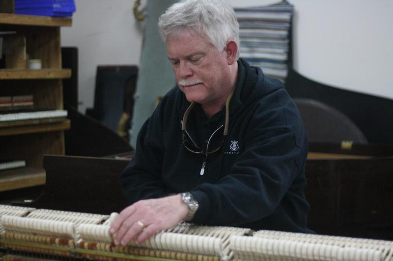 Conservatory piano technician John Cavanaugh works on a Steinway piano in the piano work- shop in the basement of Bibbins Hall. Together with a staff of three others, Cavanaugh tunes and maintains the 234 pianos which fill the Conservatory, as well as adjusts pianos to meet the specific needs of visiting pianists for their recitals.