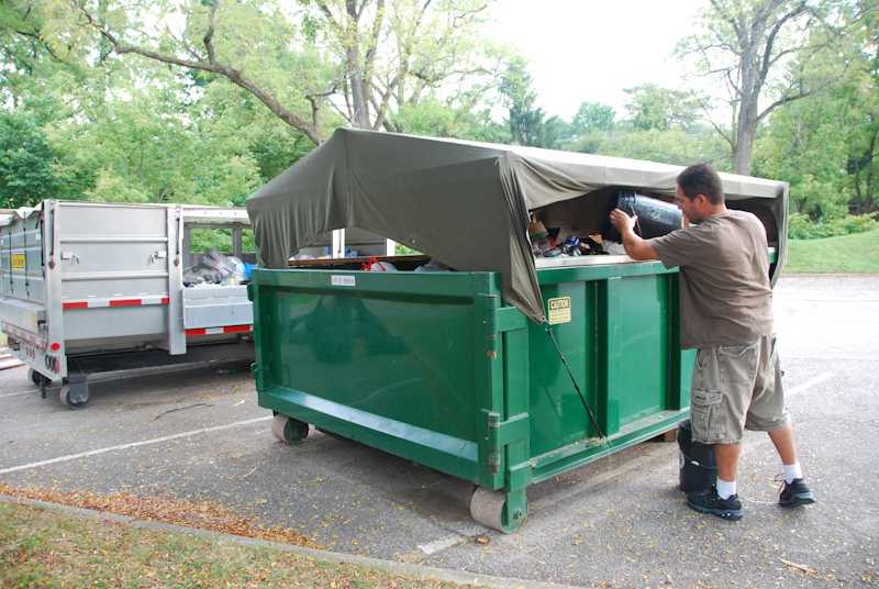 Community member Ruy Lopez disposes of his recycling in a bin behind City Hall. Oberlin’s municipal recycling pickup services halted after a fire in February destroyed the city’s garbage and recycling trucks.
