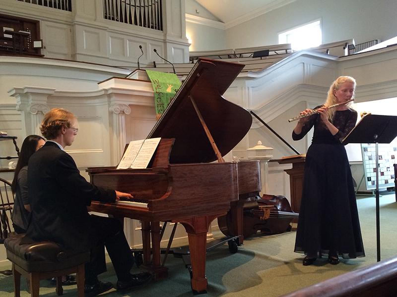 Alexa Still, associate professor of Flute, and pianist Thomas Bandy, musical coordinator of opera productions, perform Copland at the inaugural concert of the Music at the Meeting House series. Classical and Jazz faculty took the stage of First Church to unveil a newly refurbished 1911 Steinway on Saturday.