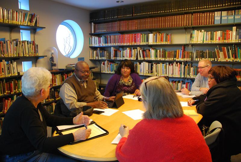 Members of the Oberlin Community Benefits Coalition meet in the Oberlin Public Library to discuss the next steps for their organization. OCBC hopes to create more jobs and further community interests by forming Community Benefit Agreements with new development projects in town.