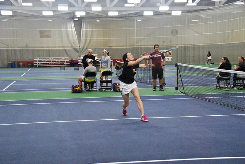 First-year Jackie McDermott lunges to hit the ball in a match against the Ashland University
Eagles on Feb. 25. The Yeowomen play their next match at home on Saturday, March 14 against
the John Carroll University Blue Streaks.