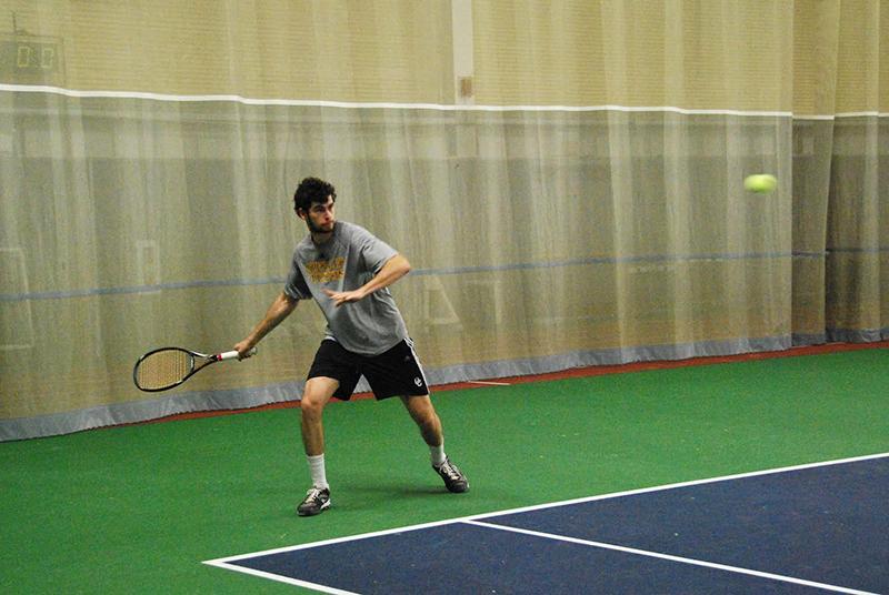 Senior captain Soren Zeliger readies himself to make a return shot in a match against the Indiana Tech Warriors. The Yeomen defeated the Warriors 7–2 to push their season record
to 3–4.