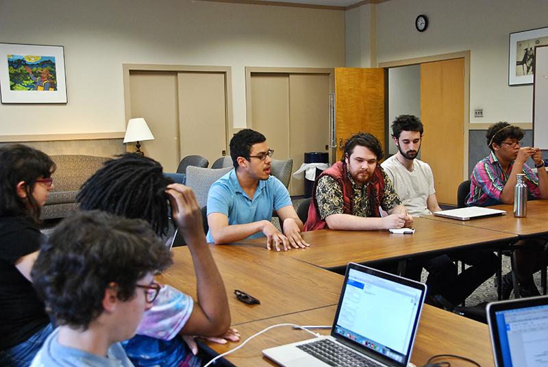 College senior Zachery Crowell (center) and student senators discuss the tuition freeze. Senators passed a resolution supporting the protests but have disagreed about the most effective way to support financial accessibility.