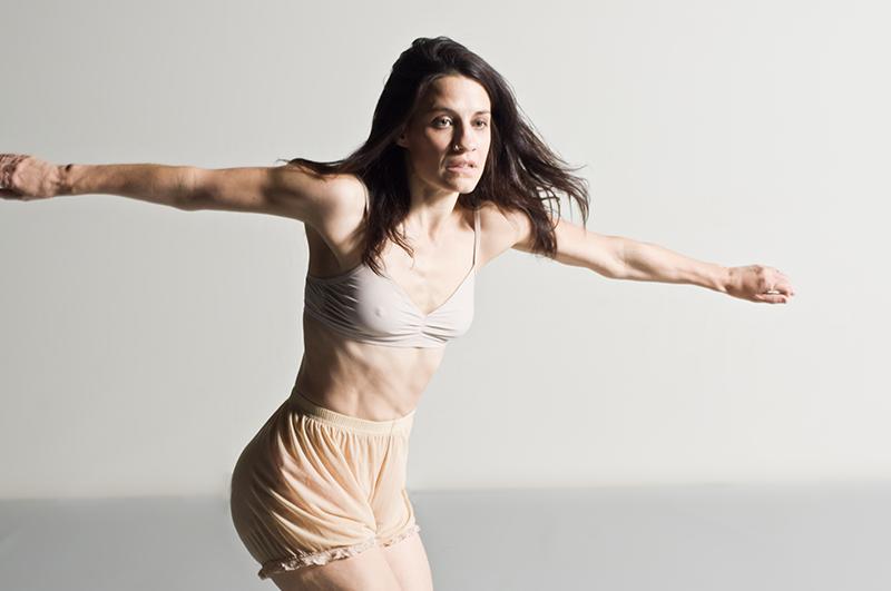 Associate+Professor+of+Dance+Alysia+Ramos+extends+her+arms+while+twisting+her+body.+Ramos+was+hired+this+semester+as+a+tenure-track+professor+and+hopes+to+bridge+the+gap+between+Euro+centric+dance+and+dance+traditions+from+African%2C+Asian+and+Latin+American+cultures.