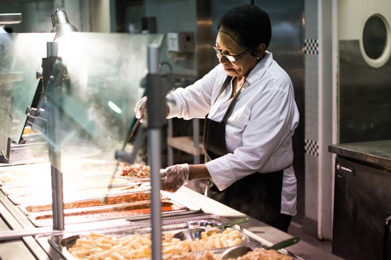 Ann Backey, an employee of the Bon Appétit Management Company, serves pasta at Stevenson Dining Hall. Campus Dining Services has recently suffered from understaffing problems, and some employees say they feel very overworked.