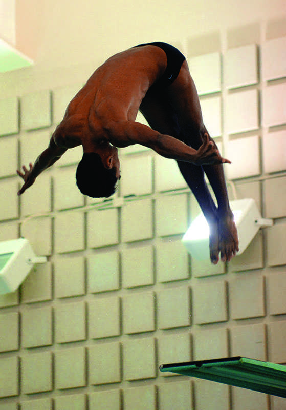 Senior diver Benjamin Miyamoto curls into his 3-meter dive at Oberlin’s Robert Carr Pool at the swimming and diving team’s home opening meet. The College of Wooster Fighting Scots defeated the Yeomen and Yeowomen 207–87 and 161–135, respectively.