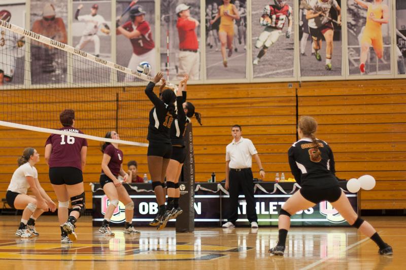 Sophomore middle hitter Dana Thomas and junior setter Meredith Leung leap to block a hit during their game against Earlham College on Sep. 26. The Yeowomen won the match 3–1 and concluded their season this weekend, finishing 2–6 in conference and 8–19 overall. 