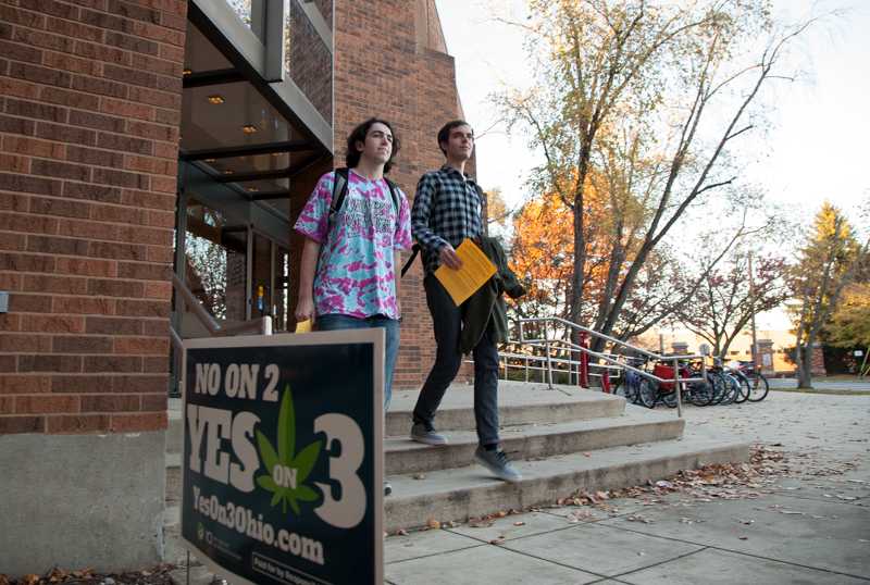 College sophomores Josh Biales (left) and Christian Bolles file out of Philips gym after casting their votes on Election Day. Ohioans voted yes on Issue 1, which calls for redrawing voting districts, and on Issue 2, an anti-monopoly initiative, but rejected the initiative to legalize marijuana.