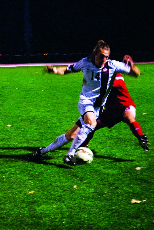 Junior forward Sam Weiss dribbles past a Little Giant of Wabash College on Saturday, Oct. 20. The Yeomen concluded their regular season with a record of 11–7–1.
