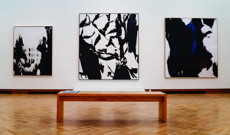 Works by Judit Reigl. LEFT: “Mass Writing,” 1965. Oil on canvas. JRZA Trust, New York. CENTER: “Man,” 1966. Oil on canvas. Lent by The Metropolitan Museum of Art, Purchase, Lila Acheson Wallace Gift, 2009 (2009.146). RIGHT: “Mass Writing,” 1961. Oil on canvas. Collection of the artist.
