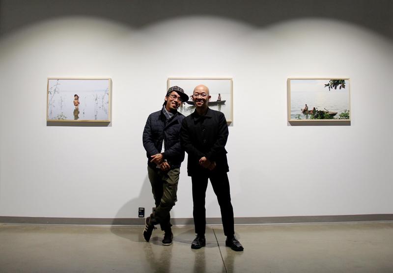 Oberlin’s Artist in Residence for February, Duy Phuong Le Nguyen (left) and Art Department Co-chair Pipo Nguyen-Duy pose in front of Nguyen’s photos in the Richard D. Baron ‘64 Art Gallery. The exhibit, Holding Water, depicts Tri An Lake in Vietnam. 