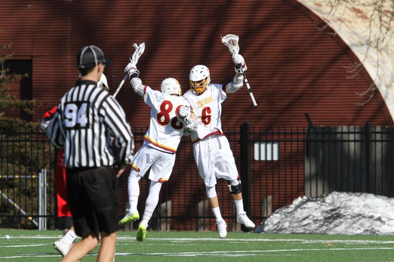 Seniors Nick Lobley (left) and Alex Wagman celebrate during the Yeomen’s home opener this weekend.  The Yeomen beat the Olivet College Comets 19–11 and will return to the Knowlton Athletics Complex to face St. Mary’s College this Sunday at 12 p.m.