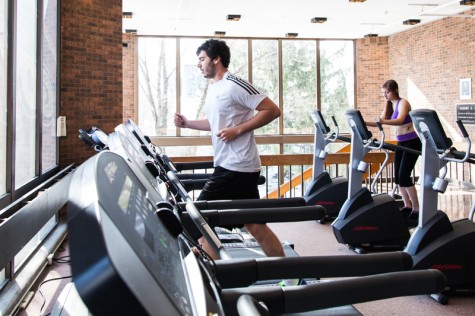 College senior Evan Lowry and Conservatory senior Jackie Meger exercise in Philips gym. The gym recently cancelled its women, trans and non-binary hour.
