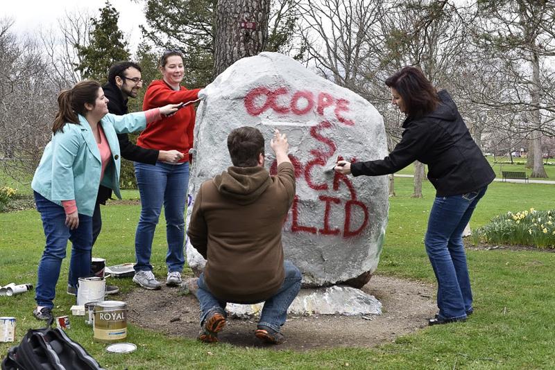 Members of Oberlin College and Professional Employees paint a rock in Tappan Square to read, “OCOPE is Rock Solid.” They will enter contract negotiations with the College on April 12.