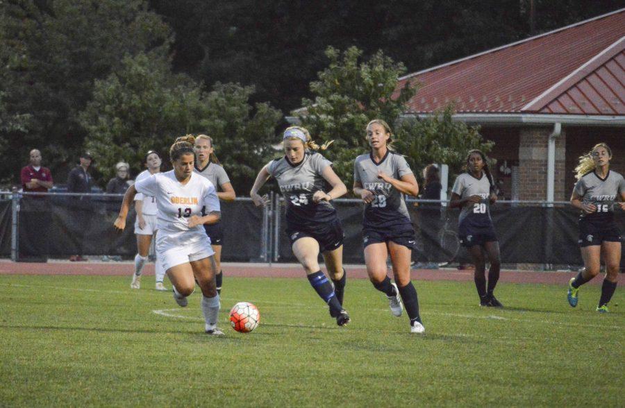 Senior center midfielder Tyler Sloan fends off a Case Western Reserve University Spartan during the women’s soccer home opener on Thursday. The Yeowomen fell to the Spartans 1–0.
