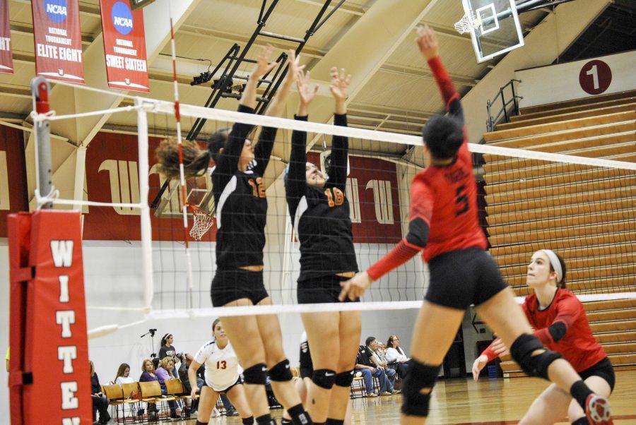 Sophomore Sara Chang (left) and senior Maggie Middleton jump for a block against the top-seeded Tigers in the first round of the North Coast Athletic Conference Tournament at Wittenberg University last Friday. 