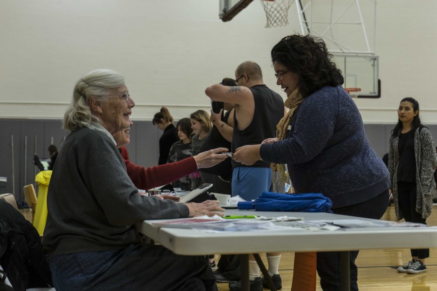 Community members check in with staff members at the polling center in Philips gym. The other polling centers in Oberlin included
the Zion Community Development building and Kendal at Oberlin.