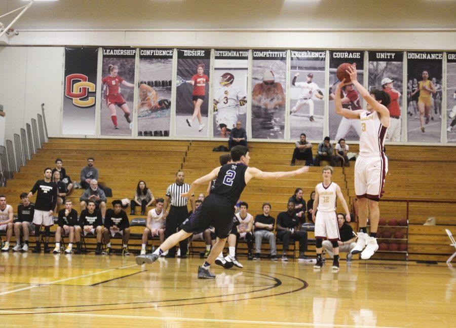 Sophomore Eli Silverman-Lloyd shoots a three-pointer in Oberlin’s 80–60 win against Kenyon College.  The Yeomen concluded their season 3–22 overall and 2–16 in the NCAC.