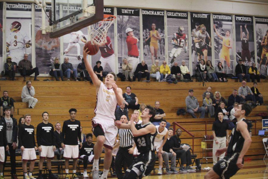 Senior Jack Poyle leaps for a layup in Oberlin’s 69–68 loss against The College of Wooster Wednesday night. 