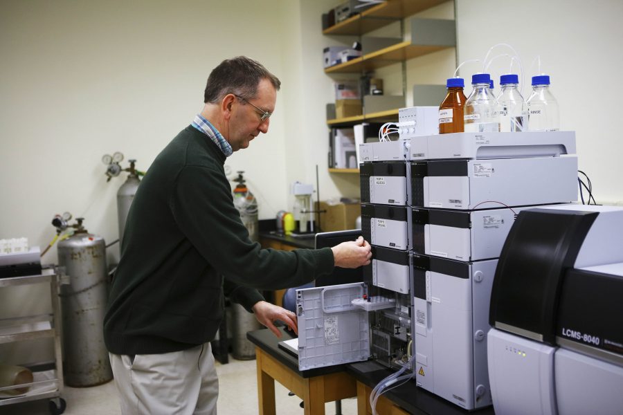 Chemistry and Biochemistry Professor Robert Thompson poses with one of the College’s new chromatograph-spectrometers. The equipment replaced 16-year-old machines. 