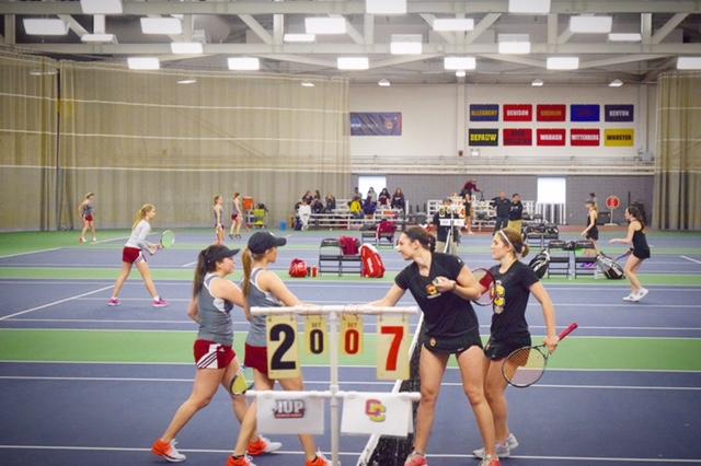 First-years Lena Rich and Rainie Heck shake hands just after match point. The duo won an exhibition doubles match at No. 4 8–2 against Indiana University of Pennsylvania. The Crimson Hawks defeated the Yeowomen 7–2 in the
second match of a home-opener double header last Saturday.