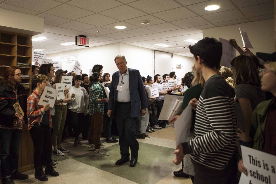 Student protestors surround Board of Trustees Chair Clyde McGregor as he makes his way to last night’s board retreat. Students expressed frustration that the trustees have not involved students in
their sessions.