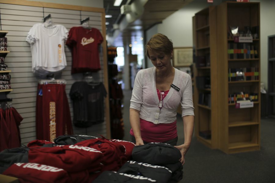 College Bookstore Manager Tammy Herman reorganizes clothes Thursday.
The College’s Purchasing Committee will soon respond to the discovery
that Nike breached the College’s Sweatshop-Free Apparel Code
of Purchasing.