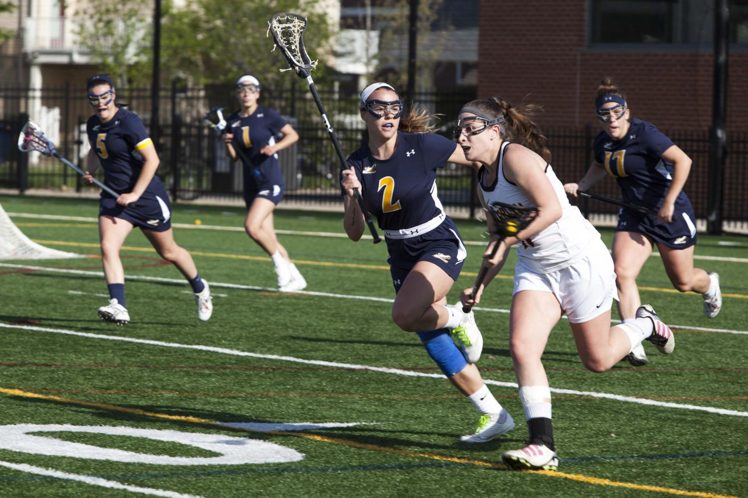 Sophomore midfielder Jenna Butler races past an Allegheny College defender in the NCAC Semifinals last Wednesday. The Yeowomen defeated the Gators 13–8 to secure a spot in the NCAC Championship for the second time in the past three years.