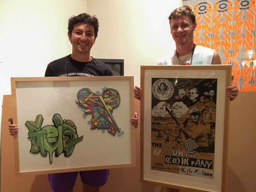 College seniors Brian James and Moses Riley hold their rented pieces, the last two available, from this year’s Art Rental event. Students who participate in one of Oberlin’s most noteworthy traditions can rent up to two pieces of art for the entire semester.