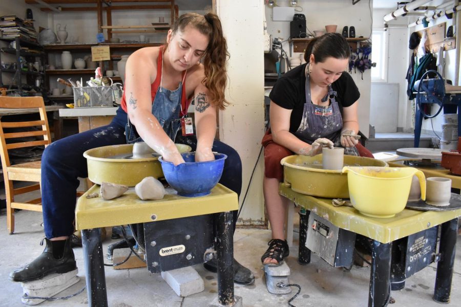 Members of the Pottery Co-Op sit at potters wheels. The co-op aims to be an inclusive space for students of all levels who want to
learn how to create pottery. 