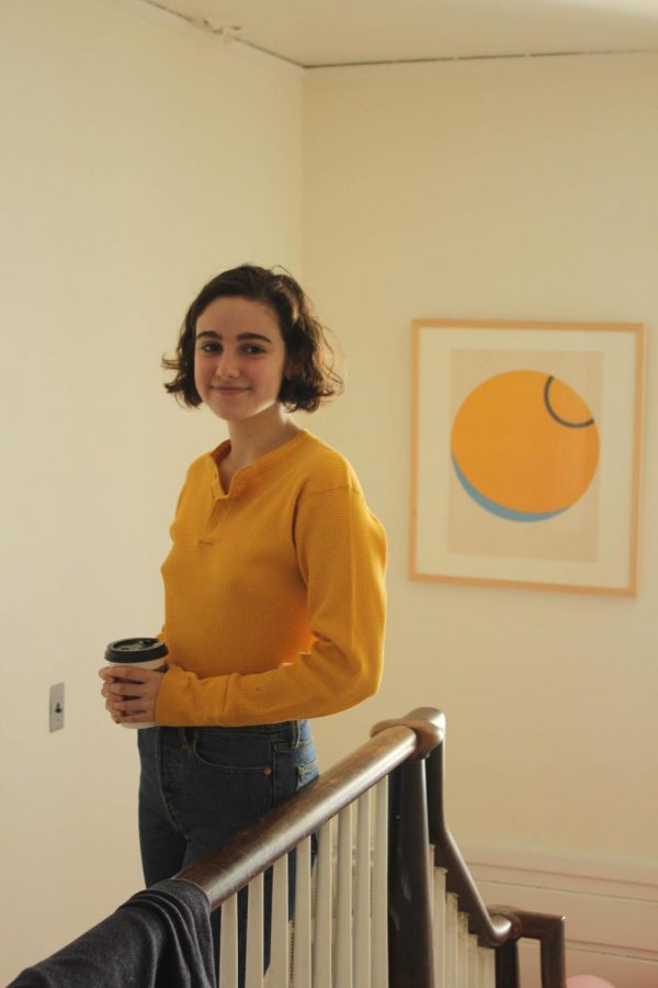 Nina Fox, OC19, stands with her art rental piece.