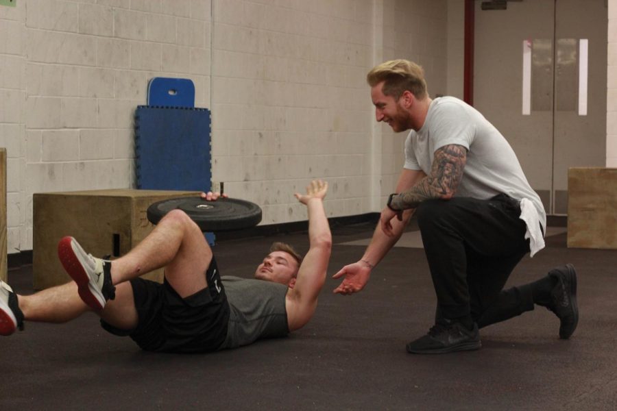 T3 athletic trainer Collin Taylor works out with College junior and football quarterback Zach Taylor.