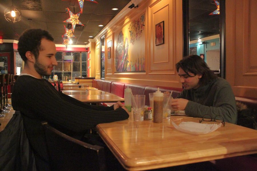 College senior Gabe Schneier and Conservatory junior Emmett Sher eat a meal at Catrina’s, Oberlin’s newest restaurant.