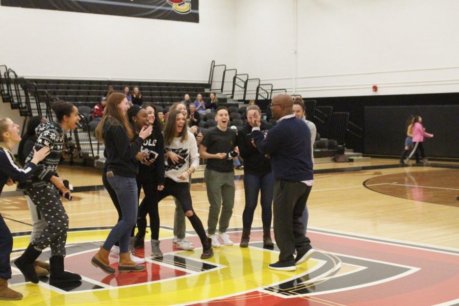 Women’s Basketball Head Coach Kerry Jenkins and his players share a laugh at the December ring ceremony celebrating their NCAC championship. Jenkins, who announced his plans to step away from the program a month ago, departs Oberlin as the winningest coach in program history.