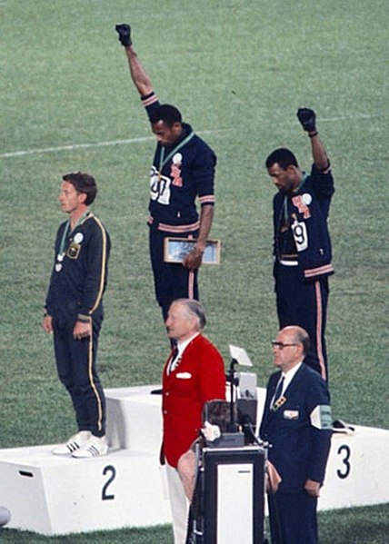 Tommie Smith and John Carlos raising a black-gloved fist at the 1968 Summer Olympics.
