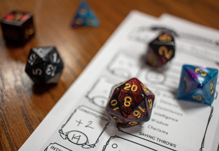 A group of students play Dungeons & Dragons in their common area. Tabletop role-playing games can foster playful, creative spaces to explore identity.