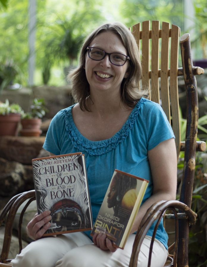 April Mather, visiting professor of Environmental Studies, holds up some of her favorite books.