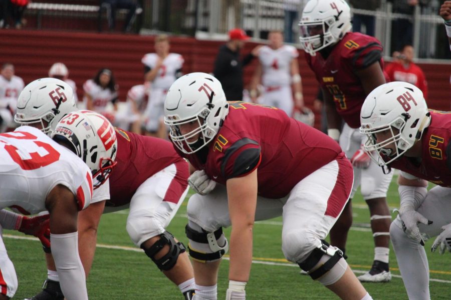 Oberlin College football’s offensive line sets up at the line of scrimmage.
