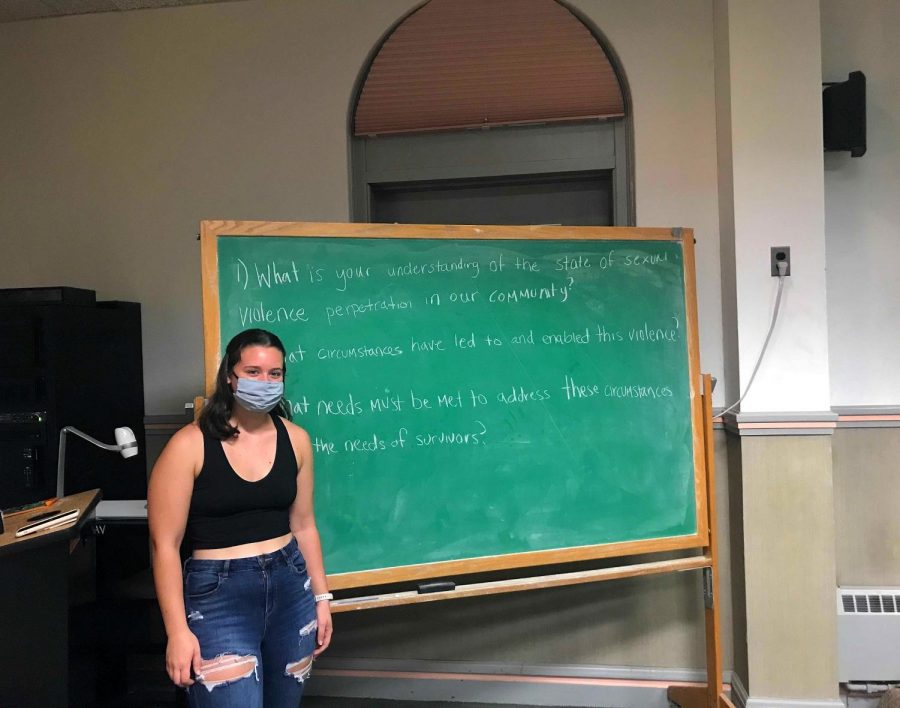 College+third-year+and+SOSHA+leader+Jenna+Frizzell+poses+in%0Afront+of+a+chalkboard+that+has+the+guiding+questions+for+last%0AThursday%E2%80%99s+Survivors+of+Sexual+Harm+%26+Allies+forum.