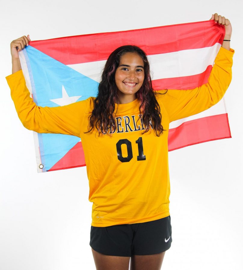 First-year women’s soccer player Adriana Morales poses with the Puerto Rican flag.
