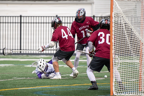 Fourth-year men’s lacrosse player Kiernan Stone checks a Capital University player to the ground.