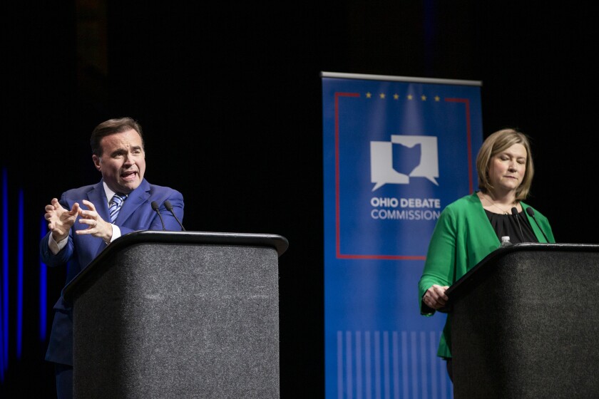 Gubernatorial candidates Nan Whaley and John Cranley appear onstage during a primary debate. 