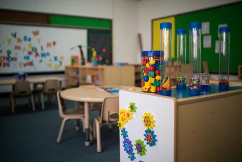 The classroom features toys, crafting supplies, and other activities for visitors.