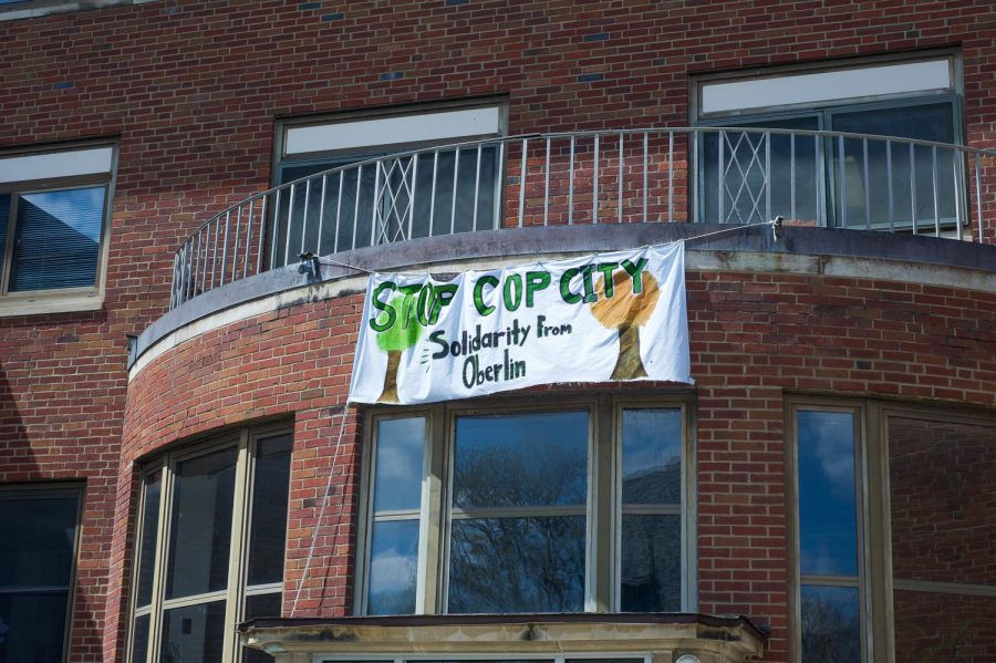 A banner hangs from Harkness Hall in support of Stop Cop City. 