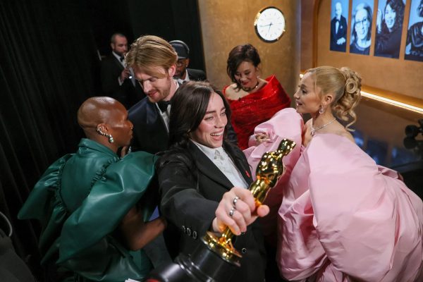 Billie Eilish and FINNEAS celebrate their Oscar award.
